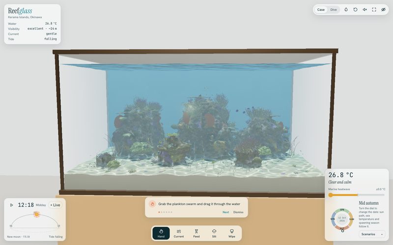 Reefglass in case view: the reef sits in a glass tank on a wooden stand, with readouts for water temperature, visibility, current and tide, a sun arc showing 12:18 midday, and a tool bar for hand, current, feed, silt and wipe.
